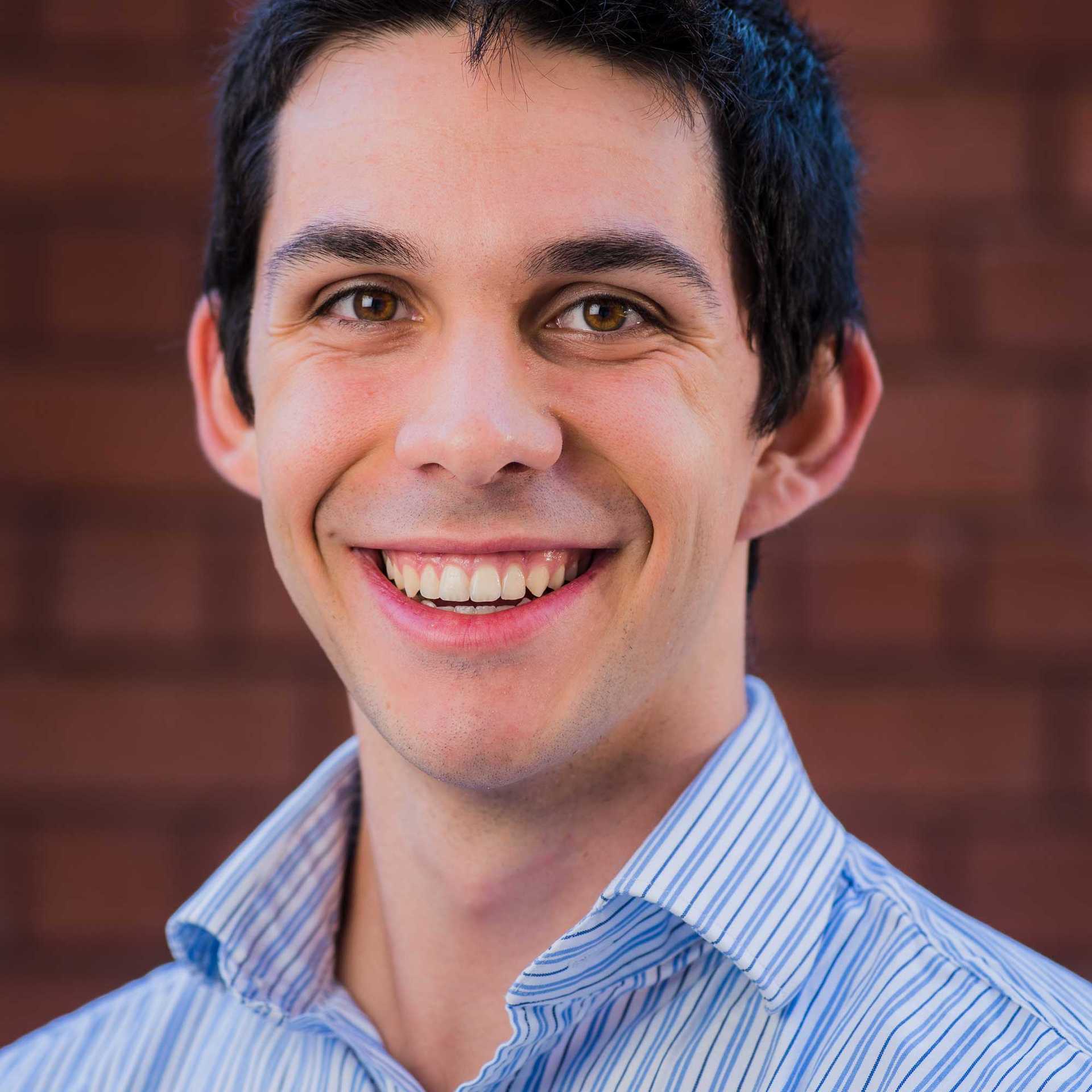 a photo of a man wearing a blue collared shirt
